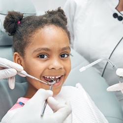 child getting their teeth cleaned by dentist